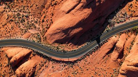 Curving Road through Desert Landscape wallpaper