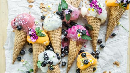 Delicious Ice Cream Cones with Toppings and Fresh Berries wallpaper