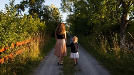 Cherished Moments of Mother and Daughter Walking Together wallpaper