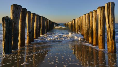 Tranquil Ocean View with Weathered Pier Stumps wallpaper