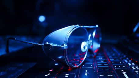 Futuristic Sunglasses on a Glowing Keyboard wallpaper