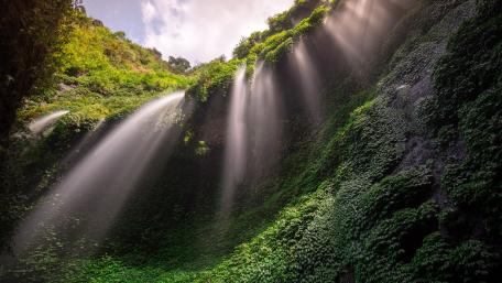 Majestic Waterfall Illuminated by Sunrays wallpaper