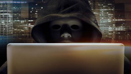 Enigmatic Hacker in the Cityscape at Night wallpaper
