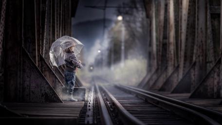 Little Girl's Rainy Railway Adventure wallpaper