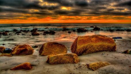Serene Sunset Over Rocky Coastline wallpaper