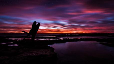 Embrace Under a Colorful Sunset Togetherness Awaits wallpaper