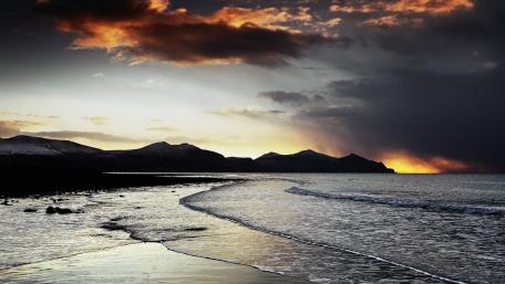 Dramatic Cloudy Beach Sunset Scene wallpaper