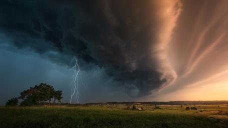 Dramatic Thunderstorm Over Grassland wallpaper