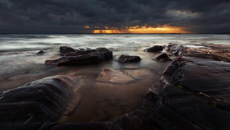 Mysterious Seascape Under Dark Clouds wallpaper