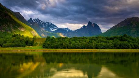 Majestic Mountains Under Dark Clouds wallpaper