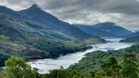 Majestic River Landscape Under Cloudy Skies wallpaper