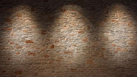 Textured Stone Wall with Subtle Lighting Effects wallpaper