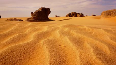 Golden Sands and Rocky Formations in the Desert Scene wallpaper