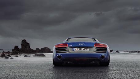 Sleek Audi R8 Facing Stormy Seascape wallpaper