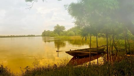 Serene Sunrise Over Tranquil Lake with Boat View wallpaper