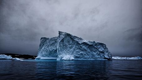 Majestic Iceberg Amidst Gray Skies wallpaper