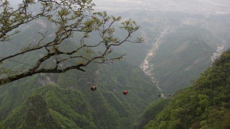 Scenic Cable Car Journey Over Majestic Valley Views wallpaper