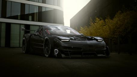 Sleek Black Chevrolet Corvette Racing Wallpaper wallpaper