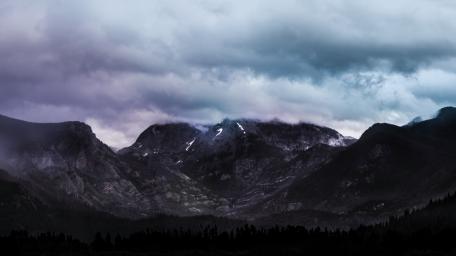 Majestic Mountains Under Dramatic Clouds wallpaper