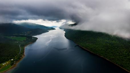 Serene Fjord Beneath Rolling Clouds wallpaper