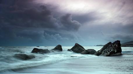 Stormy Beach View with Dramatic Clouds wallpaper