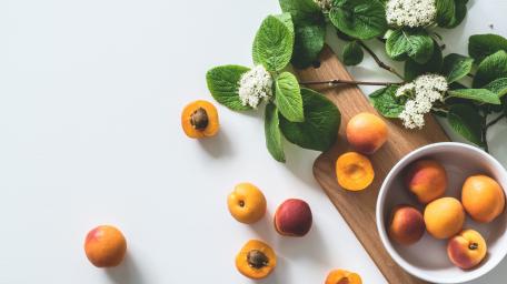 Fresh Apricots on a Minimalist Surface wallpaper