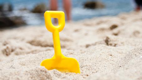 Joyful Beach Moments with Colorful Toys wallpaper