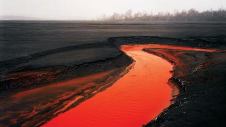 Vivid Red River in a Dark Landscape wallpaper