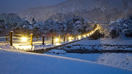 Winter Wonderland Bridge Illuminated by Snowfall wallpaper
