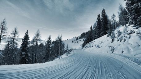 Serene Winter Road Through Snowy Landscape wallpaper