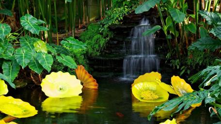 Serene Oasis with Artificial Waterfall and Lush Foliage wallpaper