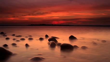 Serene Sunset Over Tranquil Lake Waters wallpaper