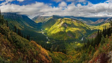 Majestic Valley Overlooking a Serene River Scene wallpaper