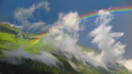 Majestic Rainbow Over Green Mountain Scene wallpaper