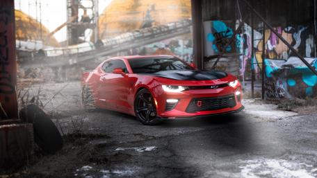 Sleek Red Chevrolet Camaro in Urban Decay wallpaper