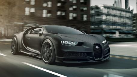 Black Bugatti Chiron Speeding Through the City wallpaper