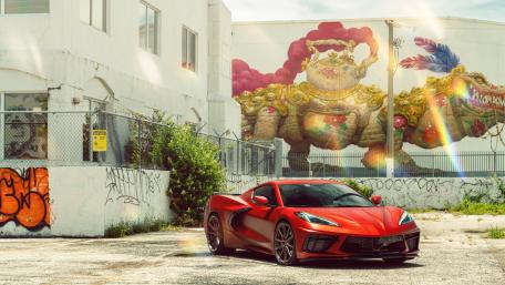 Sleek Red Chevrolet Corvette in Urban Art Scene wallpaper