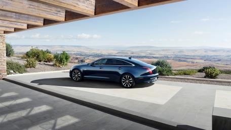 Sleek Luxury of the Jaguar XJ in Nature's Embrace wallpaper