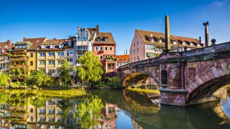 Charming Riverside View in a Vibrant Cityscape wallpaper