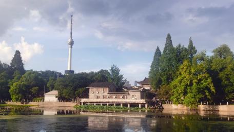 Serene Cityscape with Tower and Lush Greenery wallpaper
