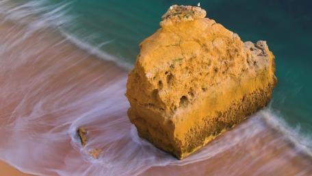 Golden Rock by the Tranquil Sea wallpaper