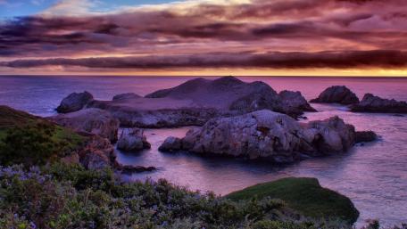 Serene Sunset Over Rocky Seascape wallpaper