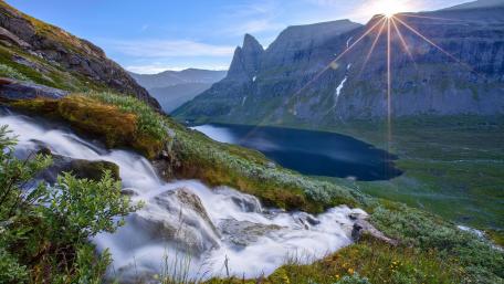 Majestic Waterfall Glimmers in Sunlight wallpaper
