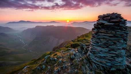 Serene Sunset Over Mountain Valley View wallpaper