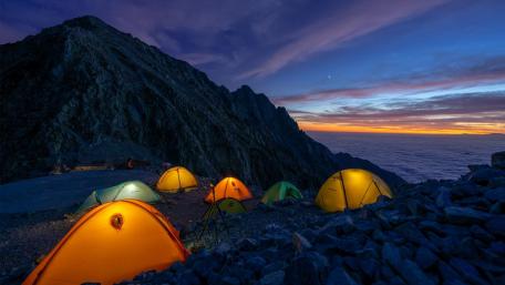 Mountain Campsite Under a Colorful Sky at Dusk wallpaper