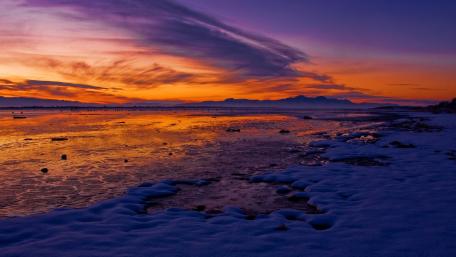 Stunning Winter Sunset Over Snowy Shoreline wallpaper