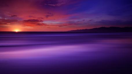 Majestic Purple Sunset Over Serene Sea wallpaper