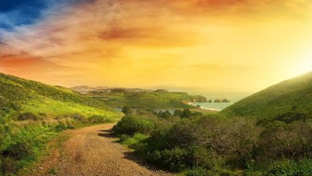 Scenic Sunset Over Coastal Roadway wallpaper