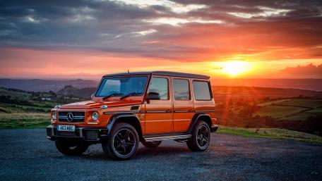 Striking Mercedes G Class Against Vibrant Sunset Landscape wallpaper