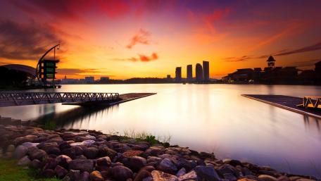 Serene City Sunset Over Calm Waters wallpaper